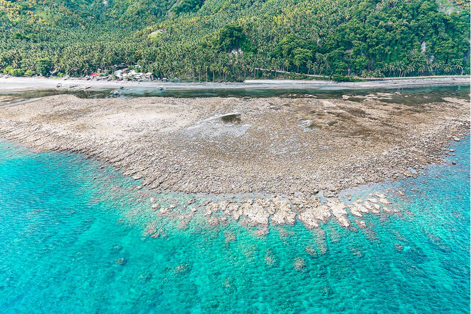 An aerial photo shows the coastal uplift following a magnitude 7.8 earthquake along the Pangyan Marine Sanctuary in Glan, Sarangani, Philippines (Photo Credit : AFP)