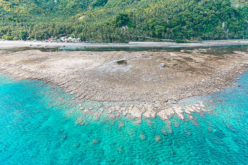 An aerial photo shows the coastal uplift following a magnitude 7.8 earthquake along the Pangyan Marine Sanctuary in Glan, Sarangani, Philippines (Photo Credit : AFP)