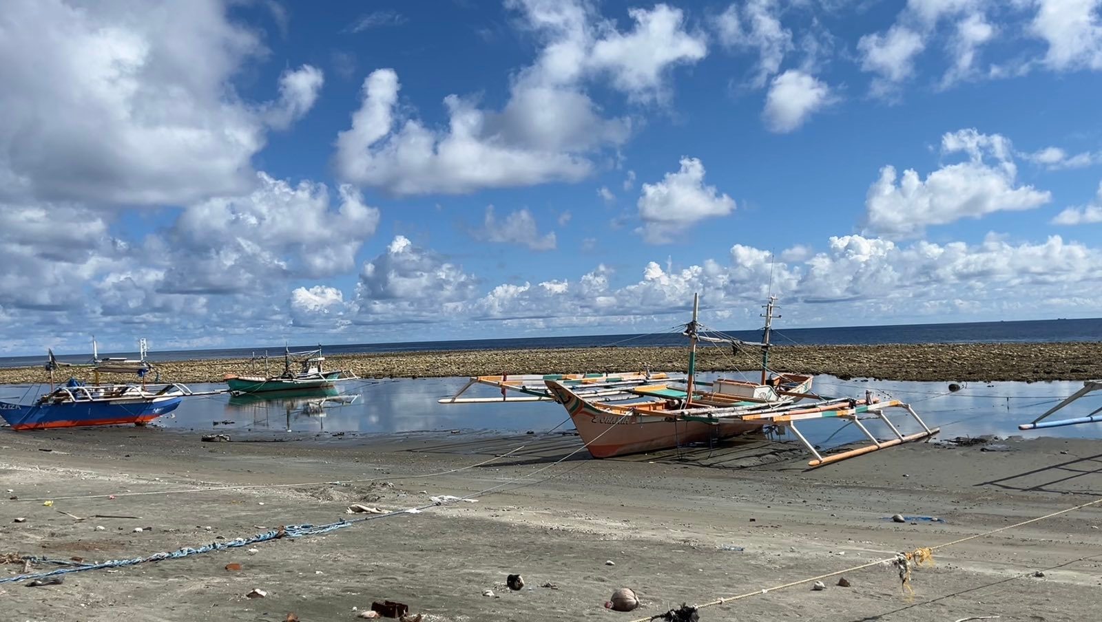 Fishing boats in Barangay Pangyan, Glan, Sarangani, are trapped as the shoreline receded by 200 meters following the coastal uplift caused by the June 8 magnitude 7.8 earthquake (Photo Credit: Jelo Ritzhie Mantaring/Rappler)